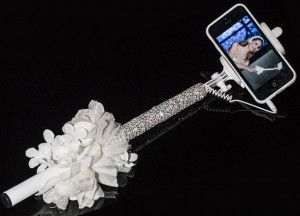 Bridal-selfie-stick-covered-in-Swarovski-crystals-and-white-blooms.