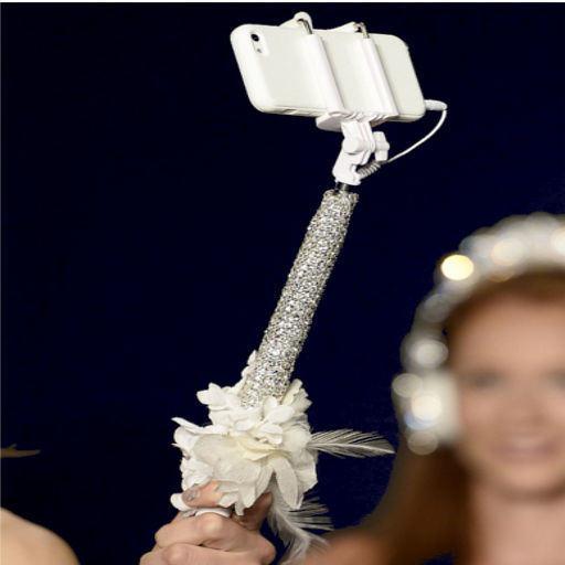 Bridal-selfie-stick-covered-in-Swarovski-crystals-and-white-blooms-by-Reem-Acra