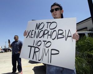 Protester-holds-up-a-sign-that-says-say-no-to-xenophobia-say-no-to-Trump