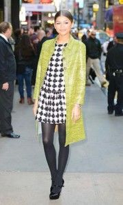 Zendaya-in a black-and-white-patterned shift-dress- and green-trench-coat-Photo-by-Raymond-Hall/GC-Images